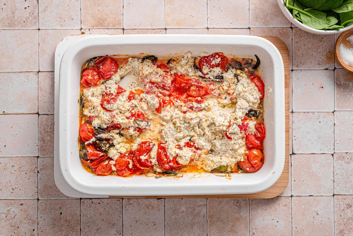 this shows me using a fork or meat masher to break apart the boursin and tomatoes after they have baked. 