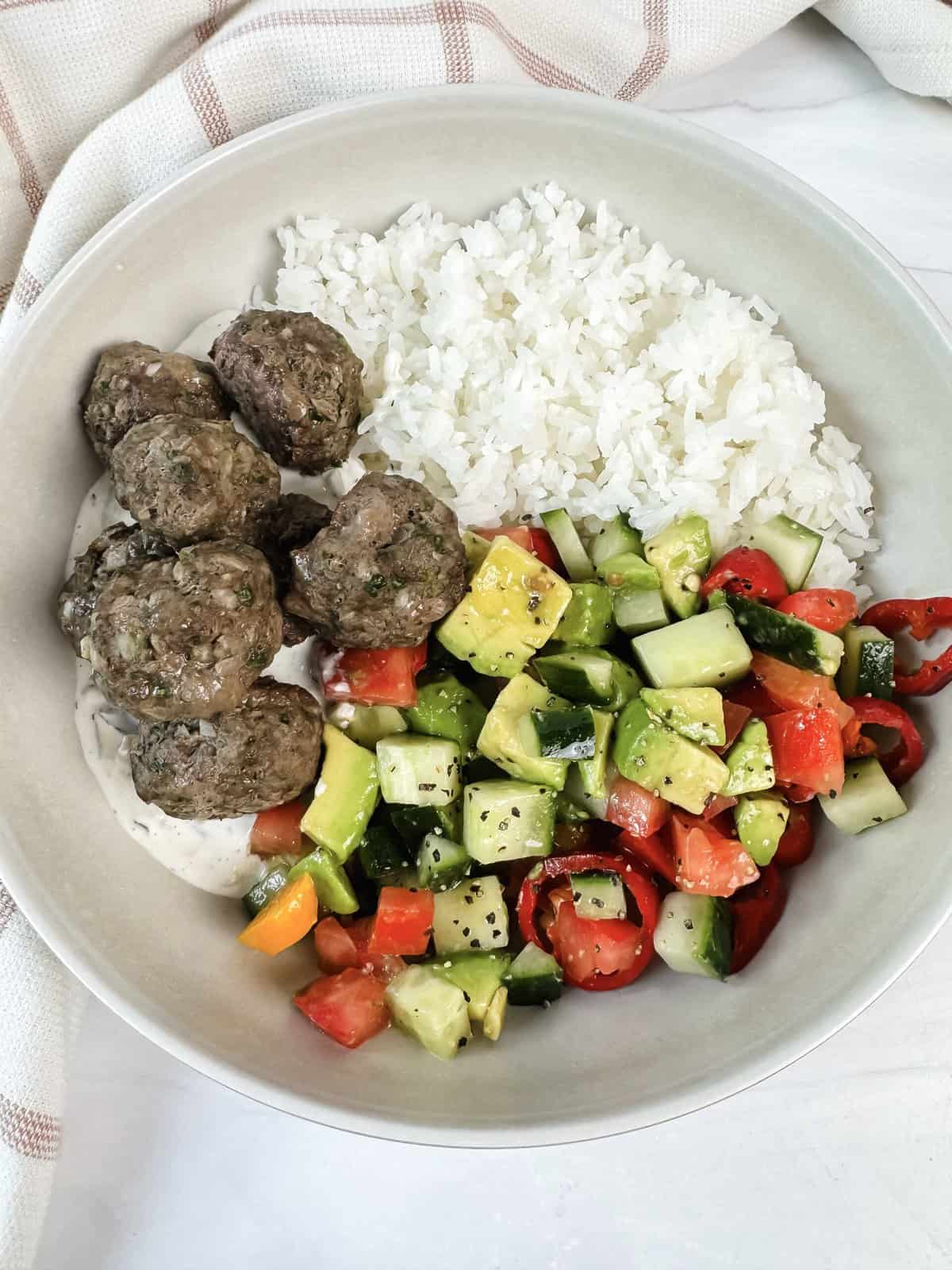 this is a close up of my kofta Lebanese meatballs with the easy side salad and white rice. 