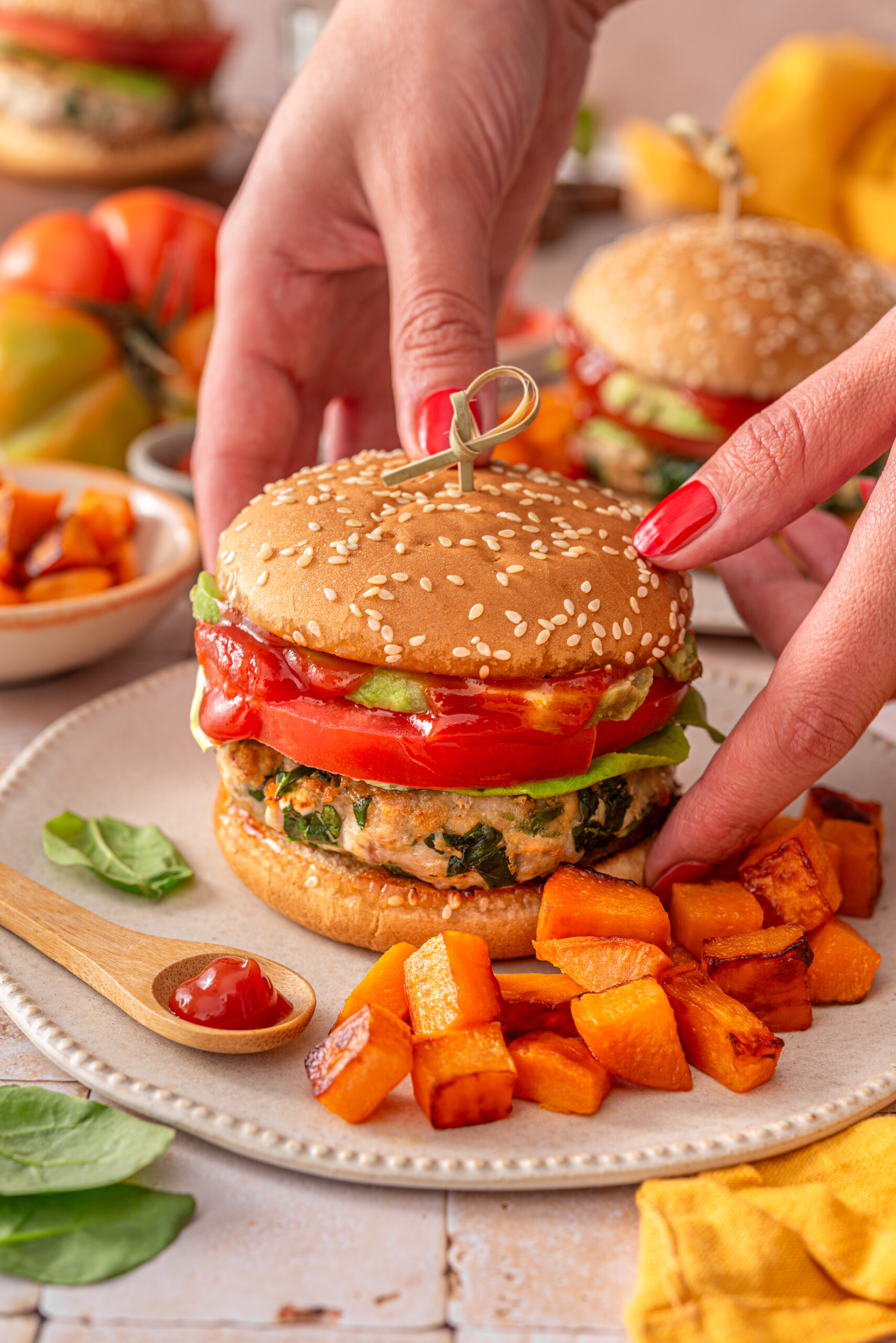 this is a side view of me putting down my healthy chicken feta spinach burgers on a plate. 