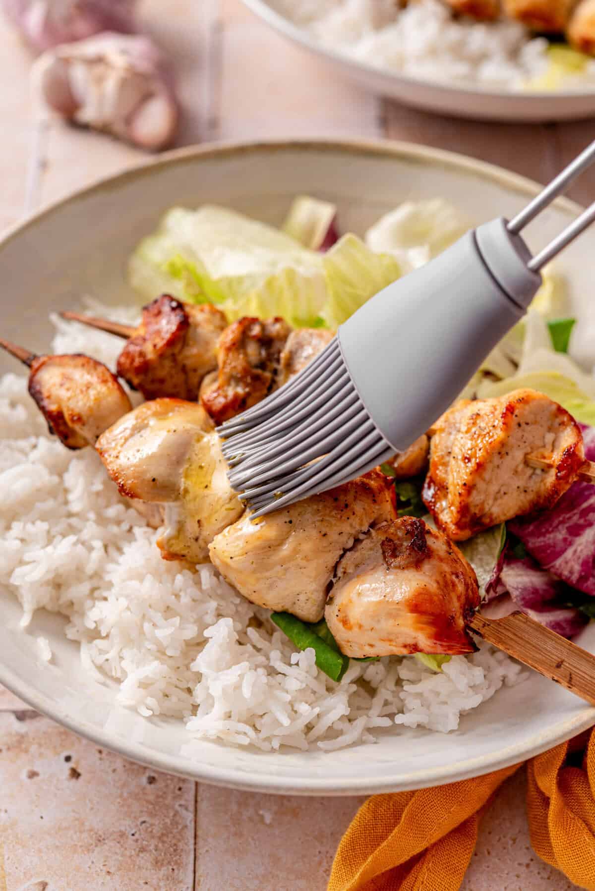 this shows me using a basting brush to cover the chicken cubes 