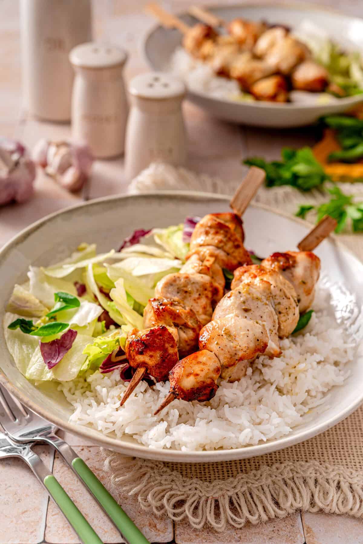 this is a side view close up of my Lemon Pepper Chicken Skewers (Air-Fryer Recipe) served with a side salad and rice 