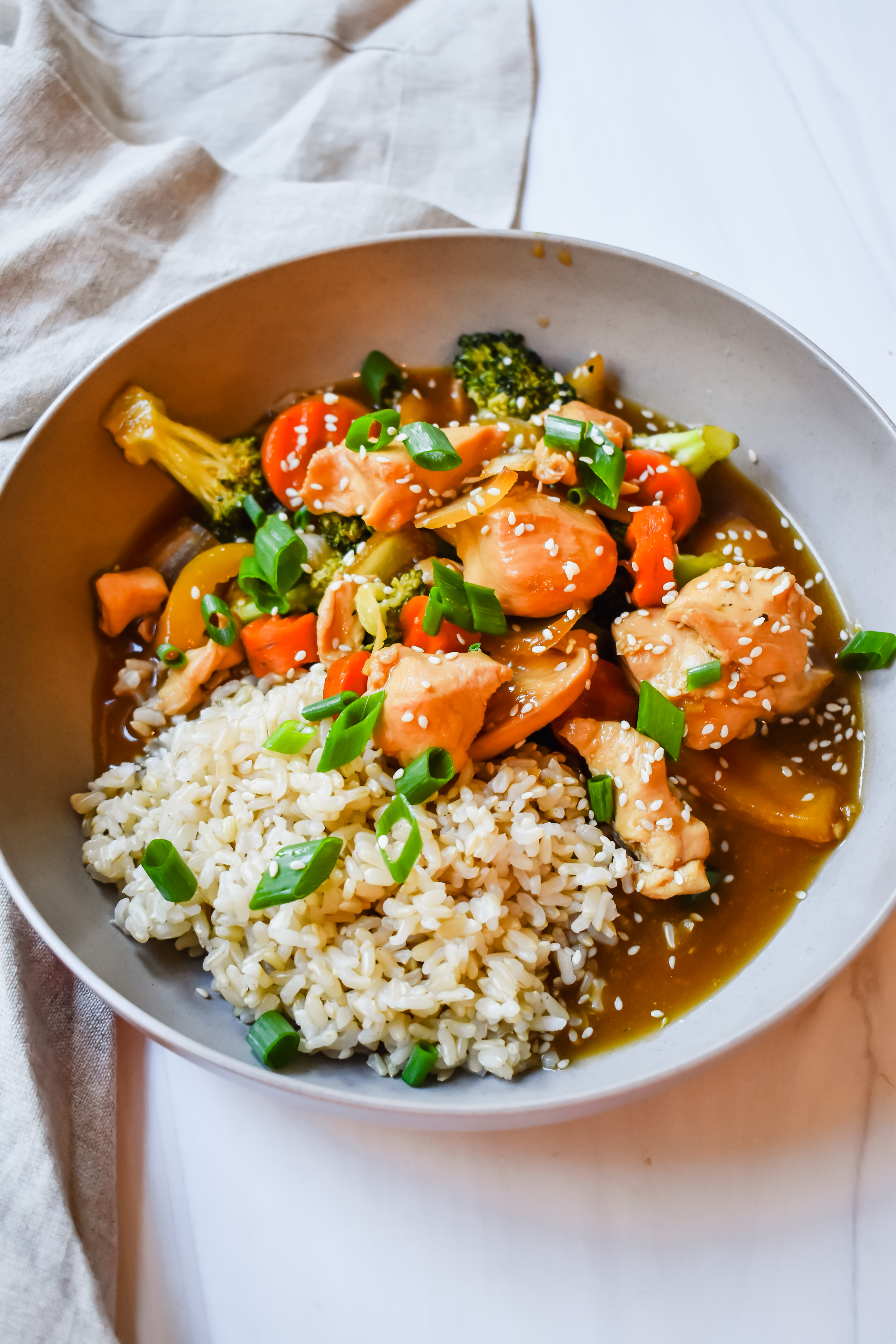 This is a side view close up of my slow cooker honey garlic chicken in a bowl 
