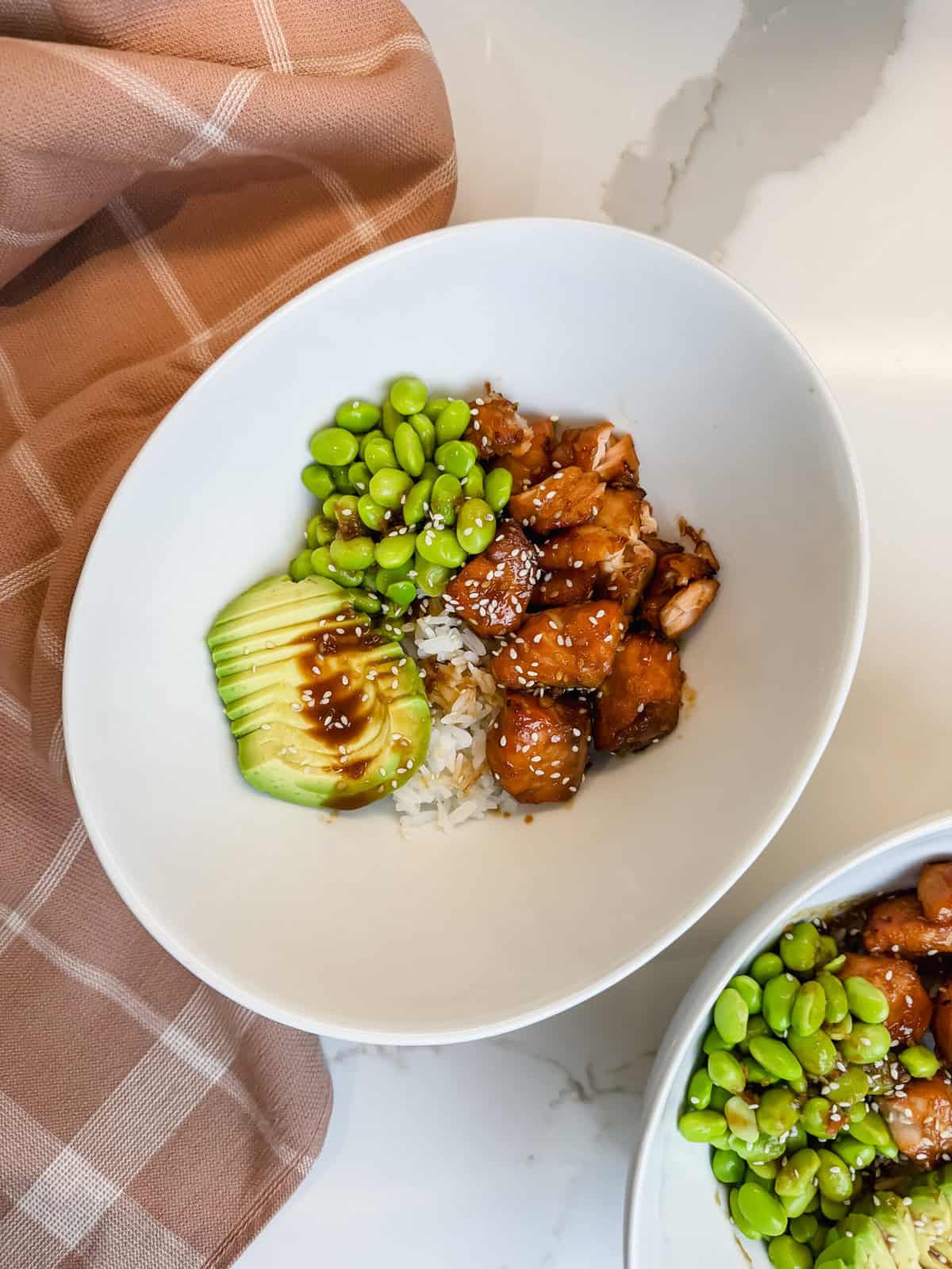 This is a top view of my Trader Joe's Salmon Bite Bowls featuring white rice, edamame, sliced avocado and delicious soyaki salmon bites. 