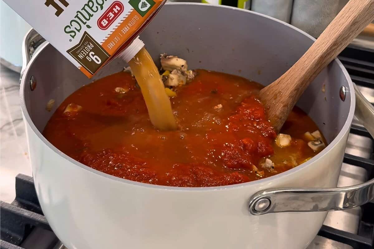 this shows me adding the bone broth to the pot. 