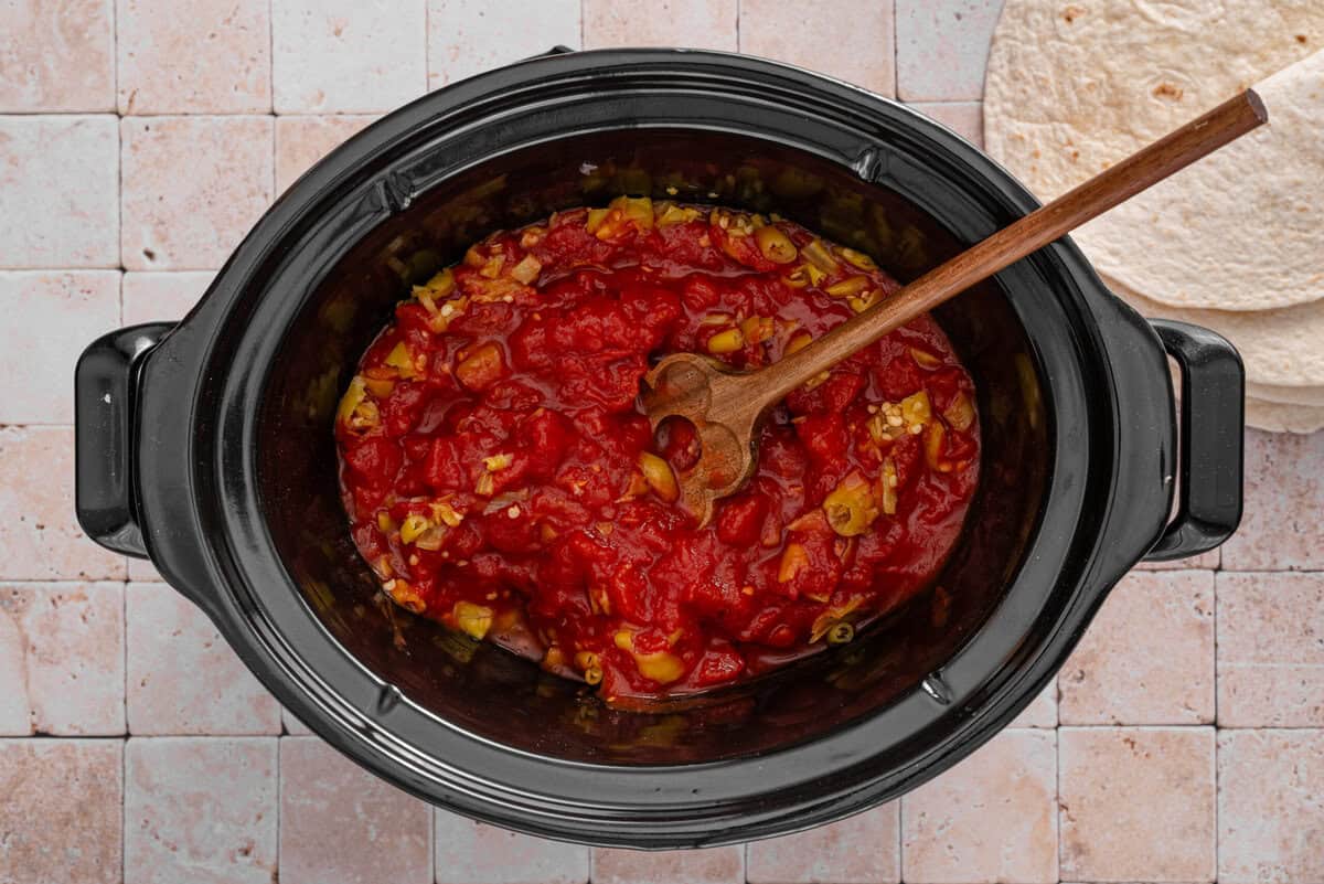 this shows me adding the rotel and other ingredients on top of the chicken 