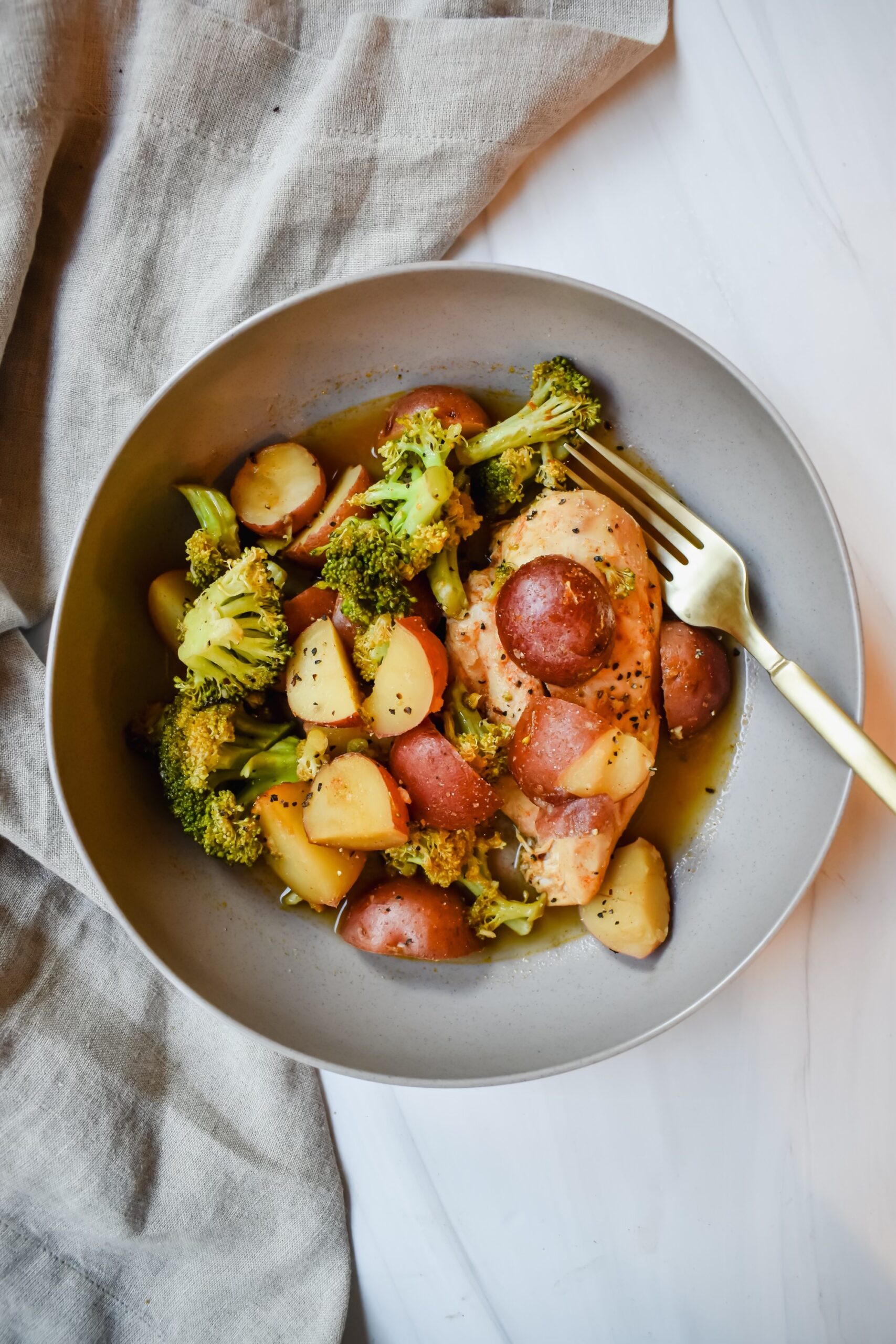 This is a top view of my crockpot lemon chicken with potatoes and broccoli in a bowl.