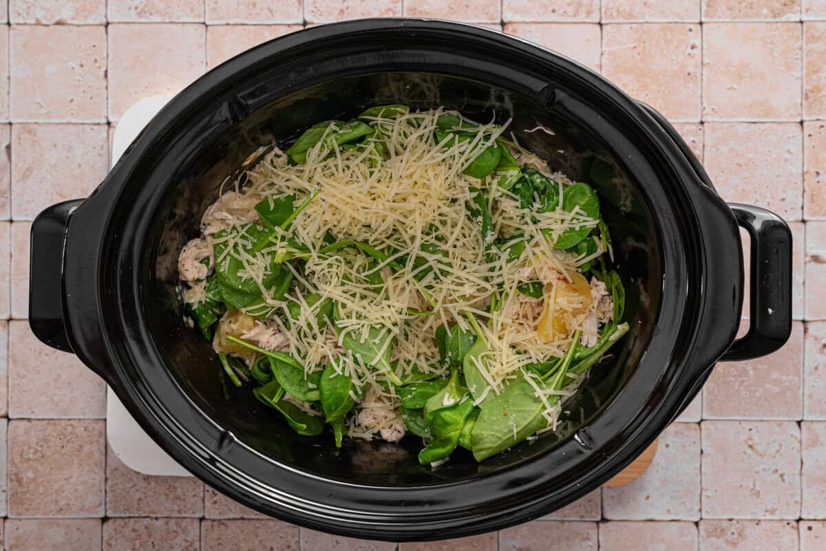 this shows me adding spinach and parmesan to the crockpot 
