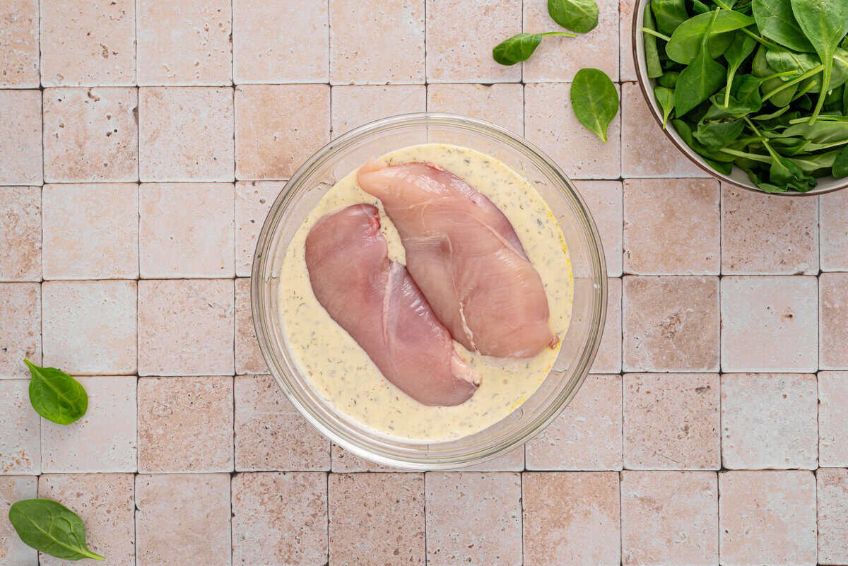 this shows me adding the chicken breasts in the dressing