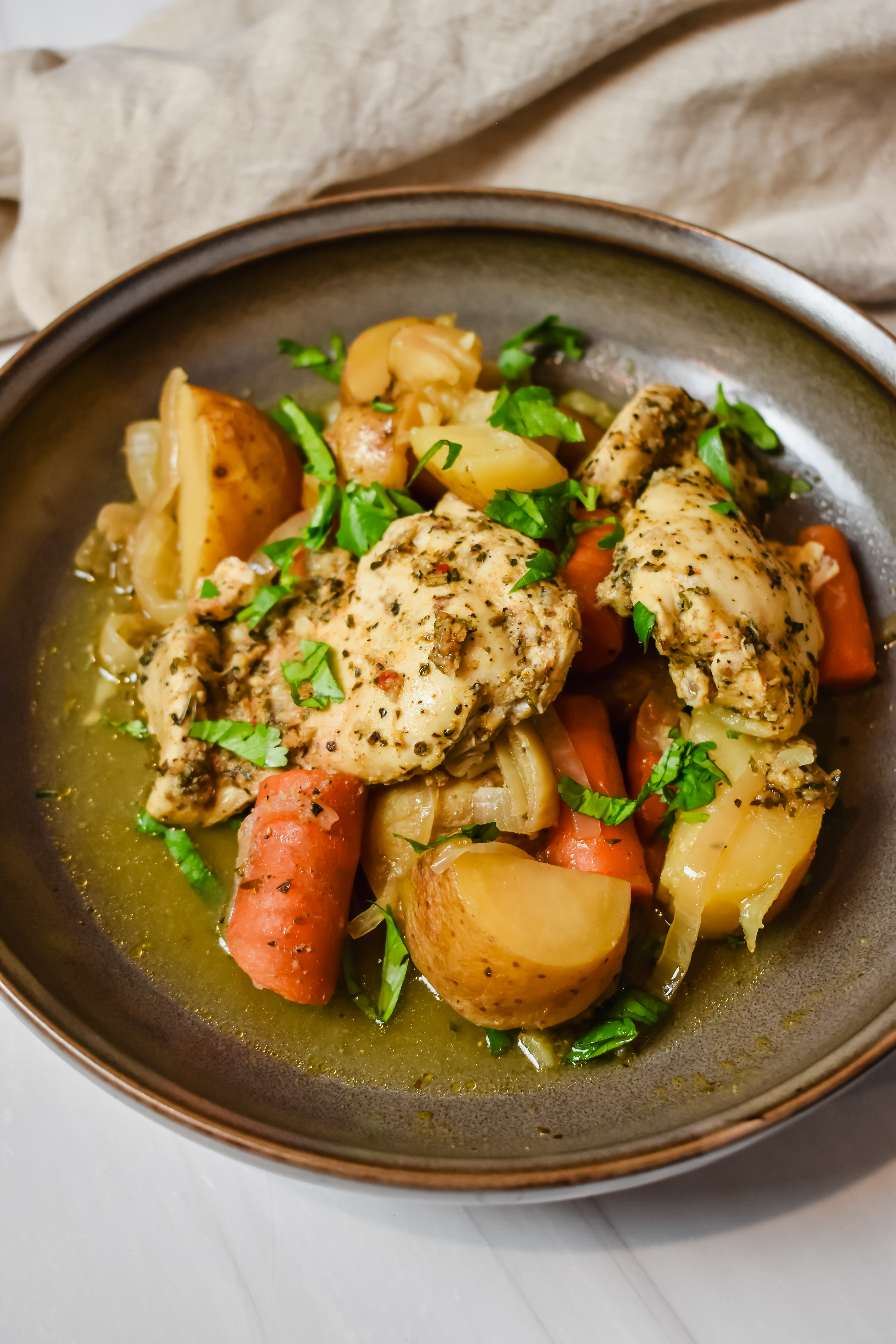 This is a top view of my slow cooker lemon herb chicken on a plate being served. 