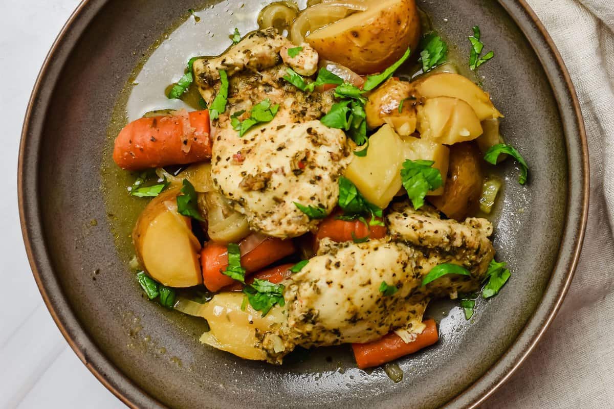 this is the final lemon herb chicken after it has been cooked served on a plate.