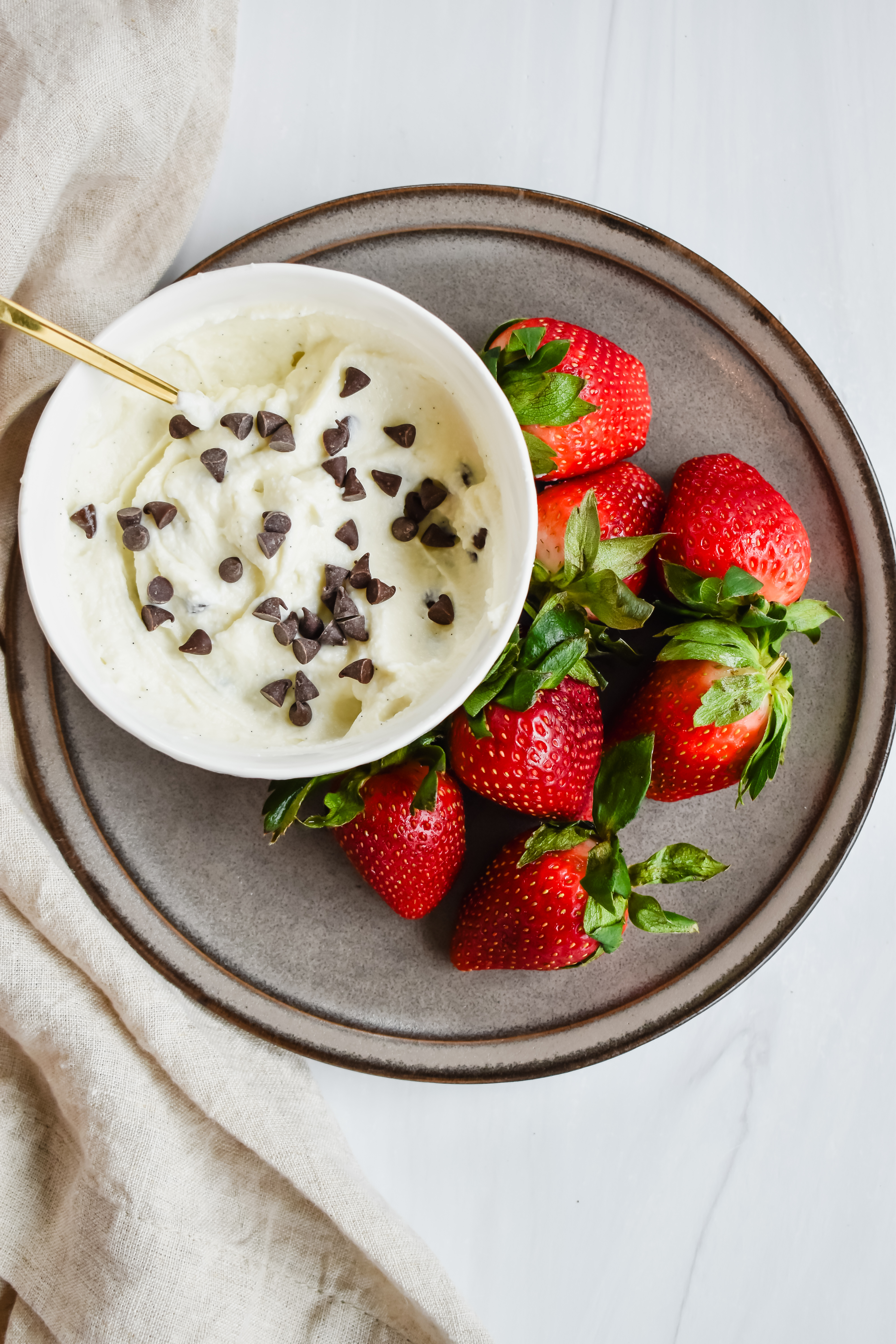 this is a top view of my healthy cannoli dip served alongside strawberries as a dipping vessel. 