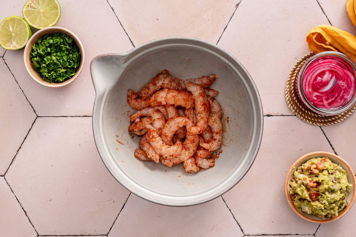 this shows me tossing my seasoning with shrimp