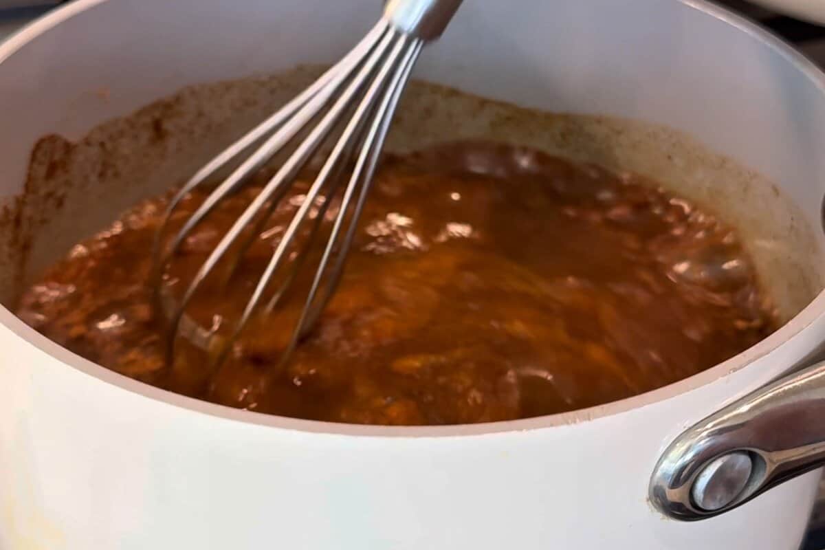 this shows me whisking everything together and then letting everything cool.