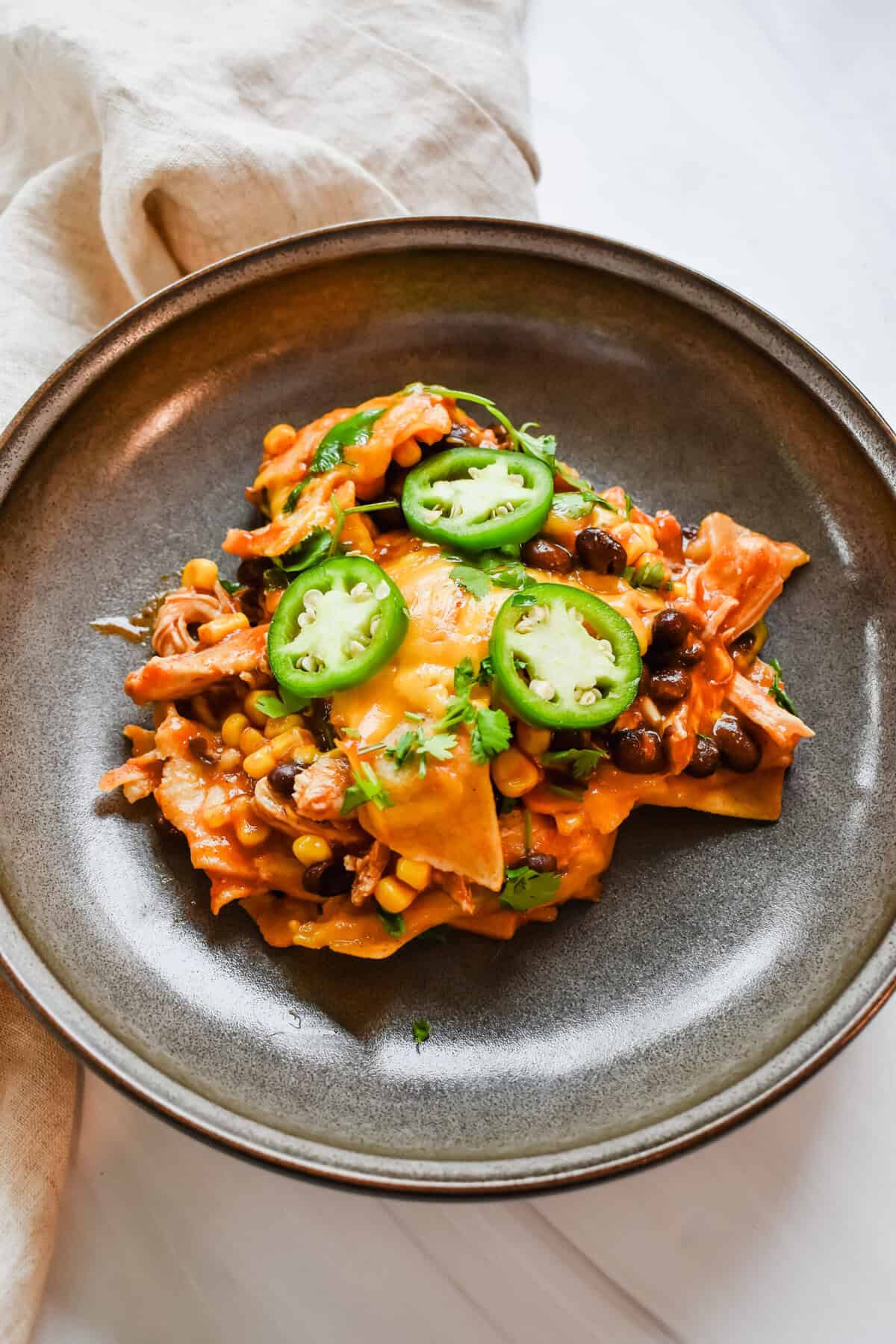 another side view close up of the chicken enchilada casserole in the dish. 