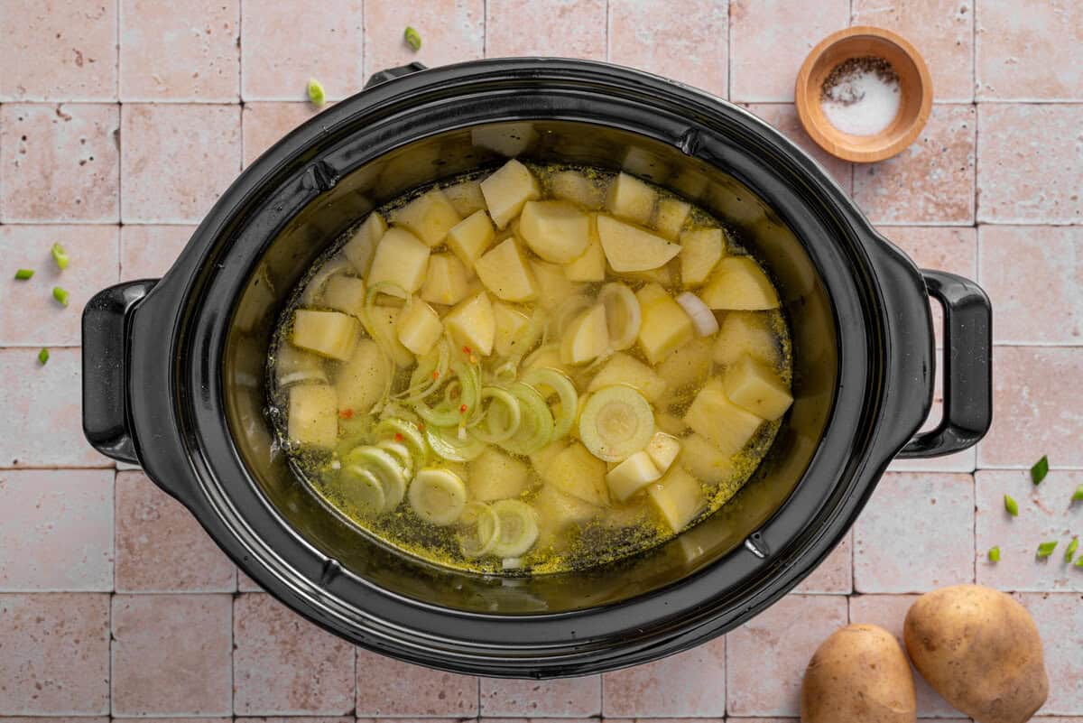 this shows me adding the potatoes, leeks, onions and chicken bone broth to a slow cooker