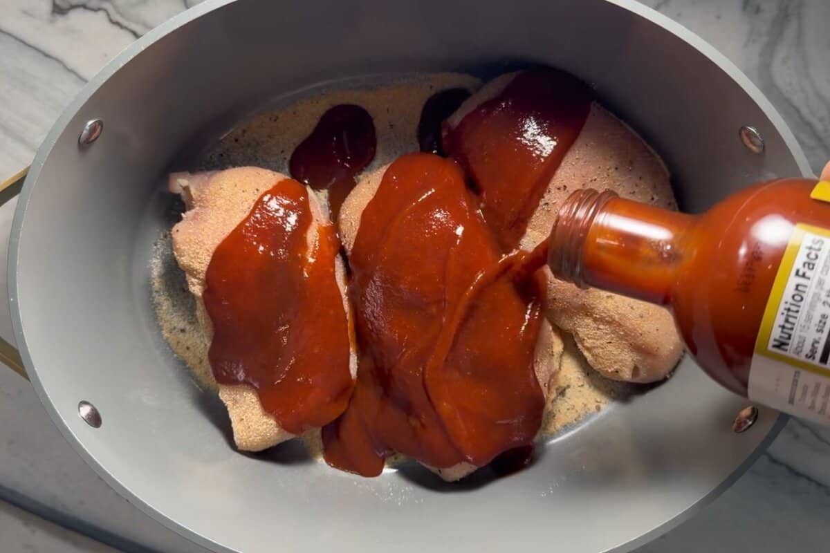 this shows me adding the bbq sauce to the crockpot