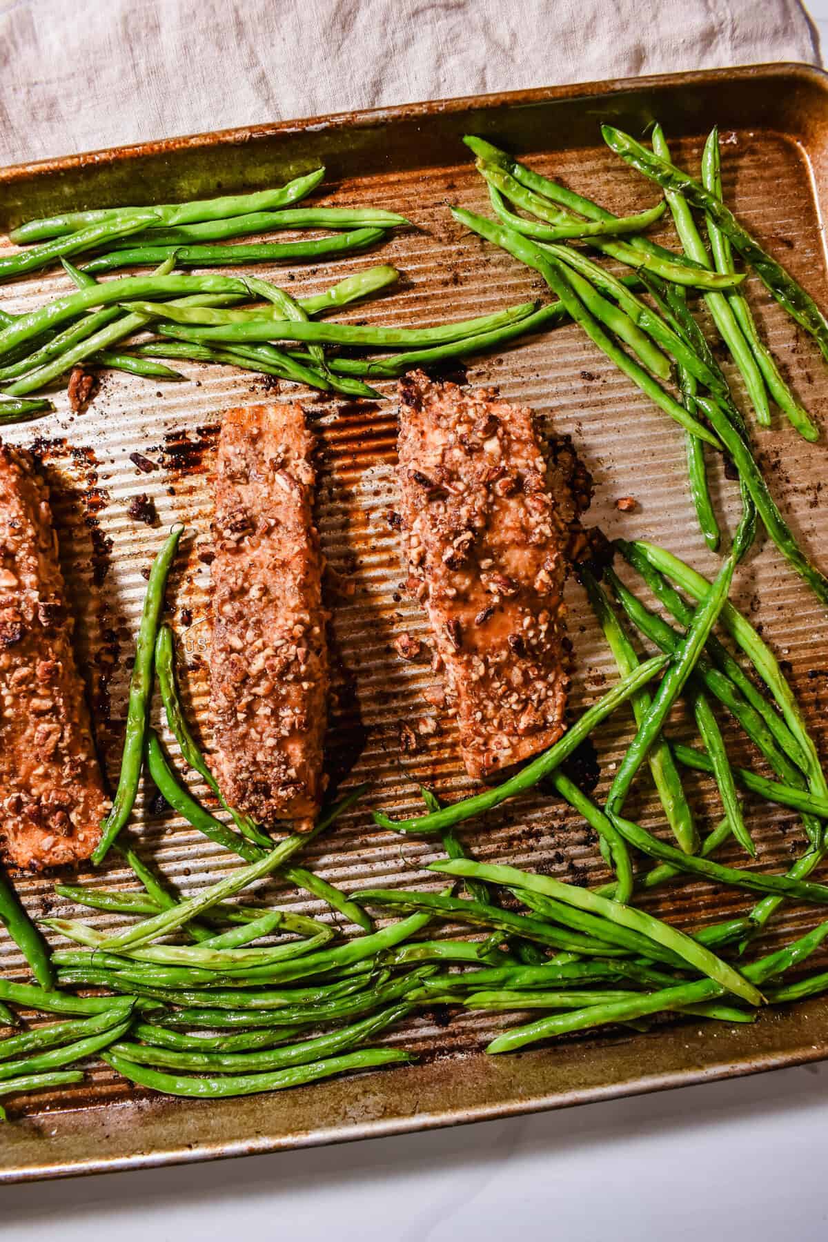 this is a top view of my pecan crusted salmon in a pan with the green beans
