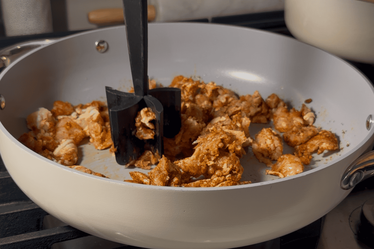 Cooking protein on a large skillet for exican stir fry.