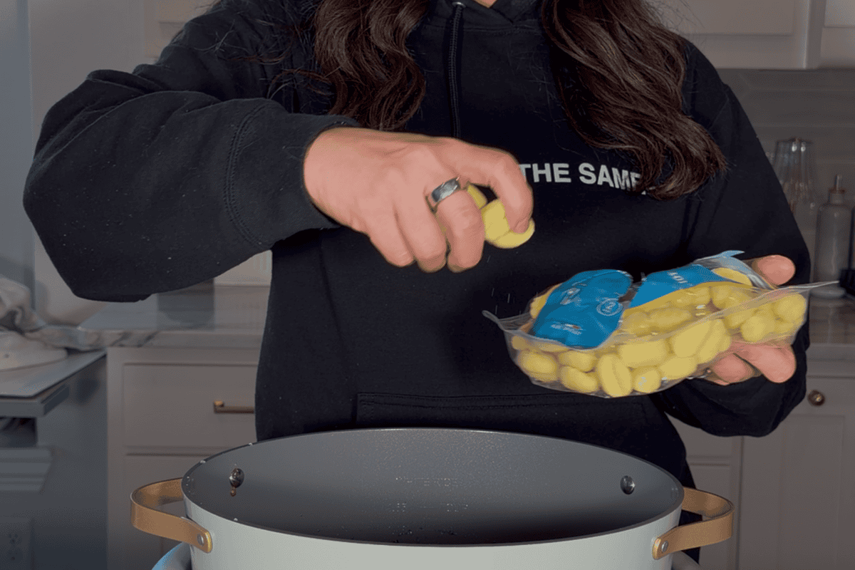 Adding gnocchi to crockpot for the slow cooker balsamic chicken.