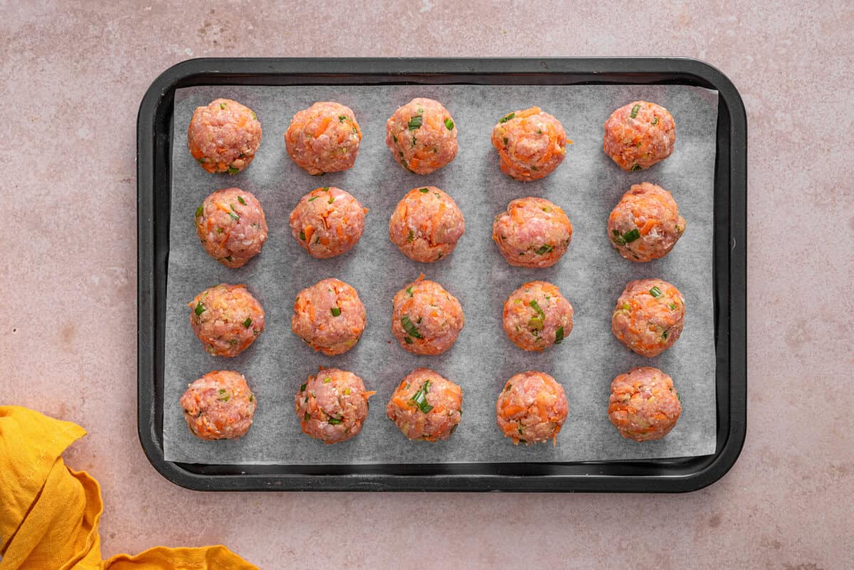 this shows me placing the meatballs on a parchment lined baking sheet. 