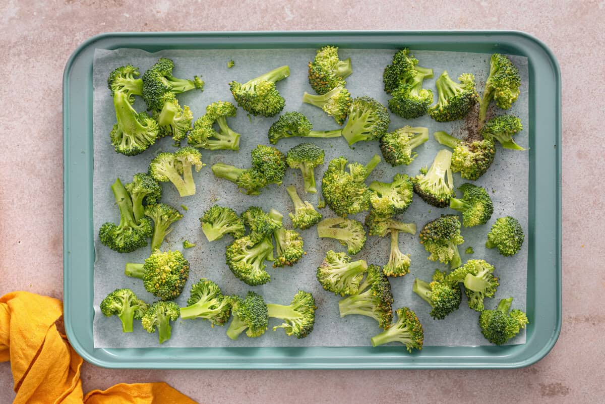 this shows me adding the broccoli to a parchment lined sheet pan 