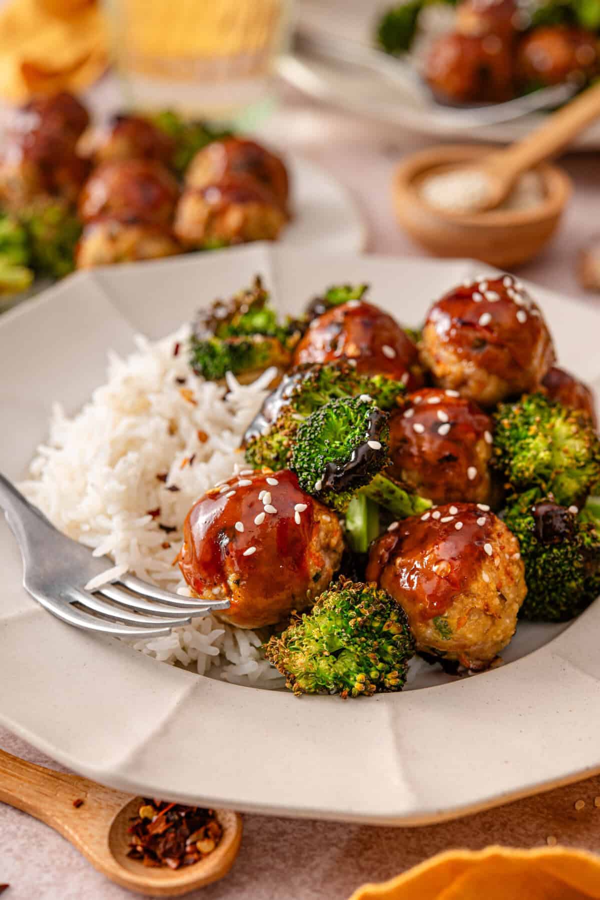 this is a side view close up of my easy asian style chicken meatballs with broccoli and rice 