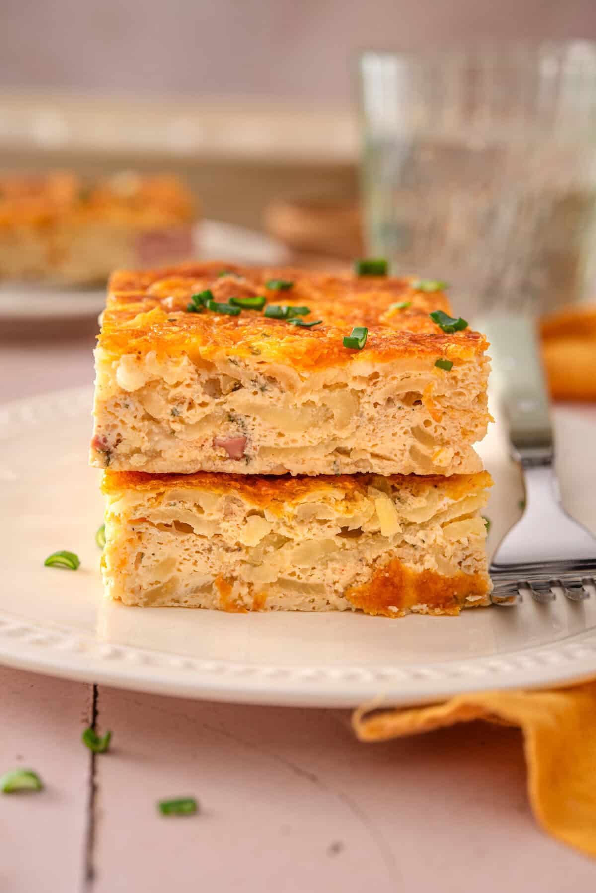 side view of my easy and healthy hash brown breakfast casserole on a plate stacked on top of each other. 