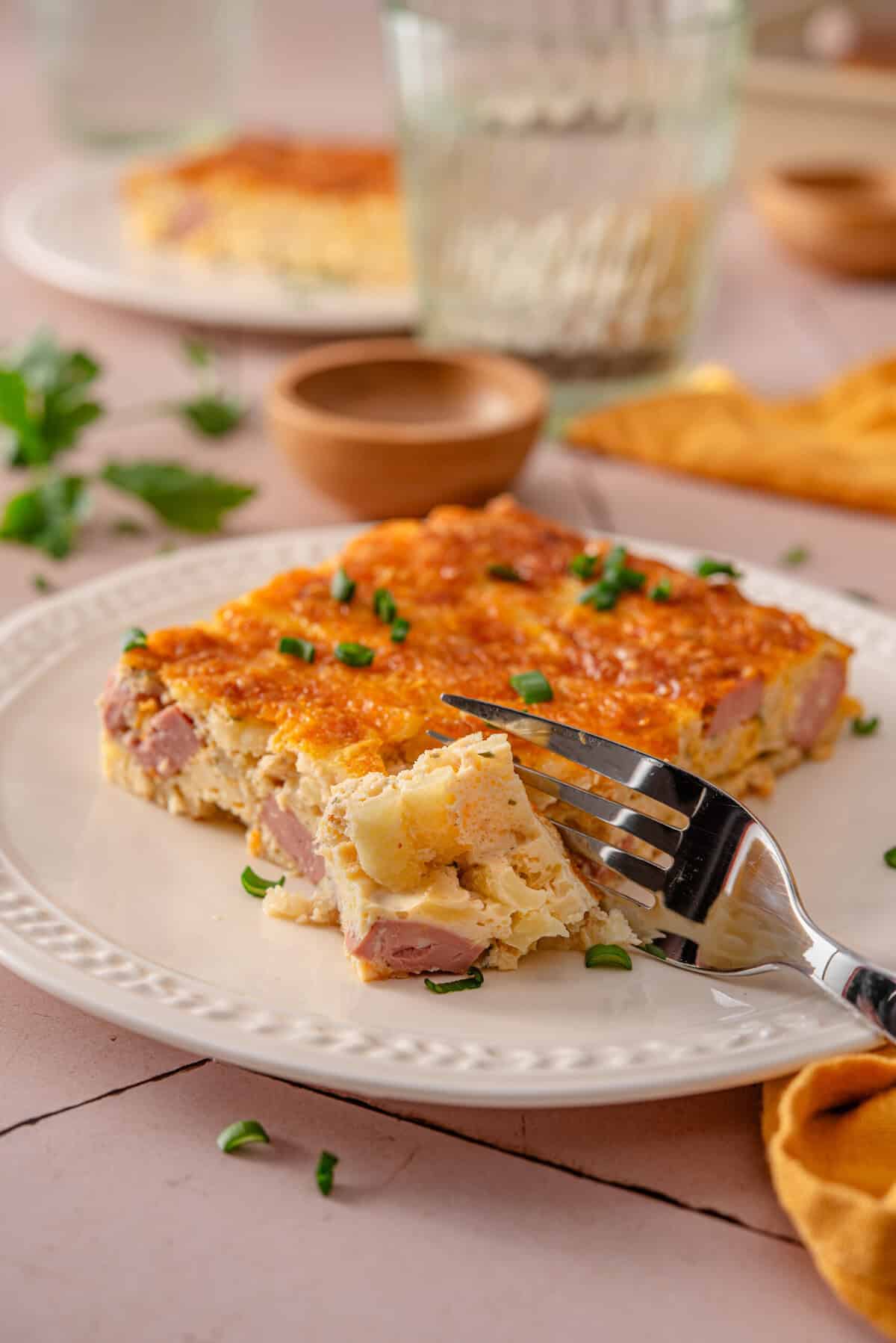 side view of my easy and healthy hash brown breakfast casserole being cut into 