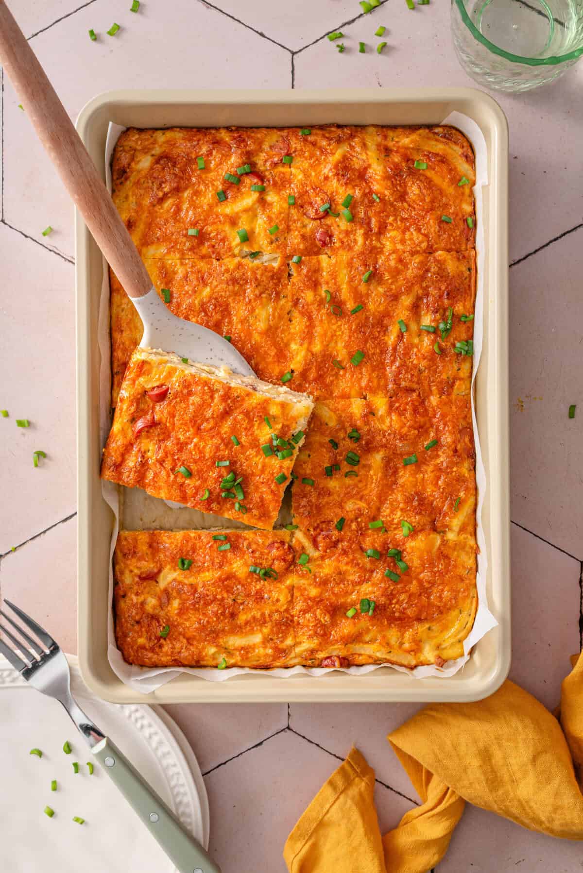 top view of my easy and healthy hash brown breakfast casserole in the pan cut into slices. 
