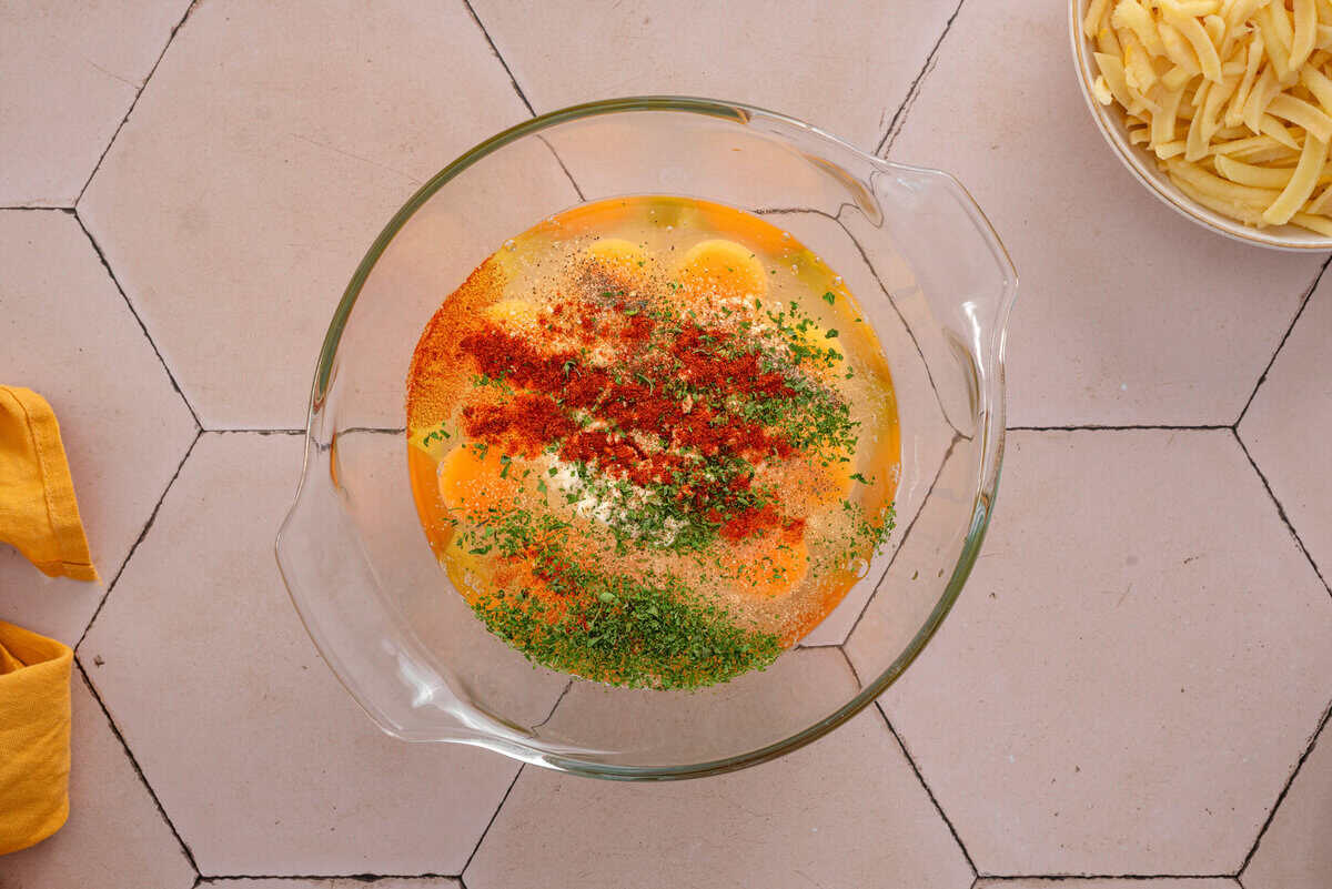 shows the egg mixture in a bowl with seasonings 