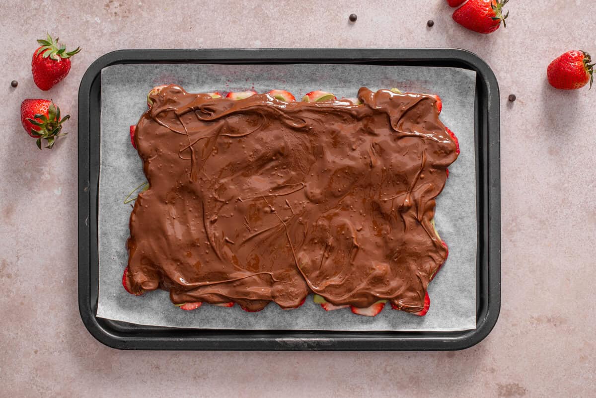 this shows me adding melted chocolate on top an even layer before freezing. 