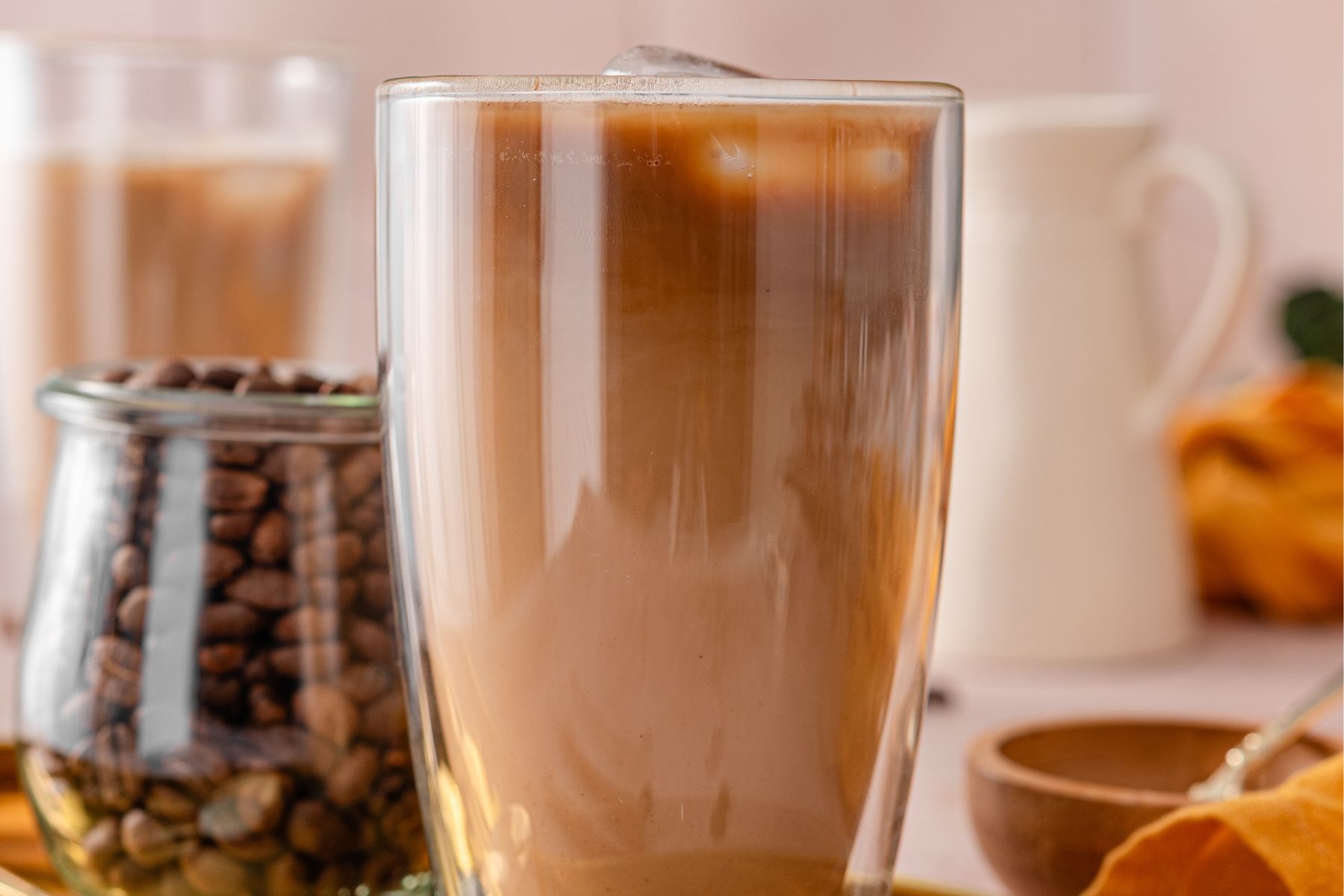 this shows me adding my milk of choice and then ice cubes to the glass. 