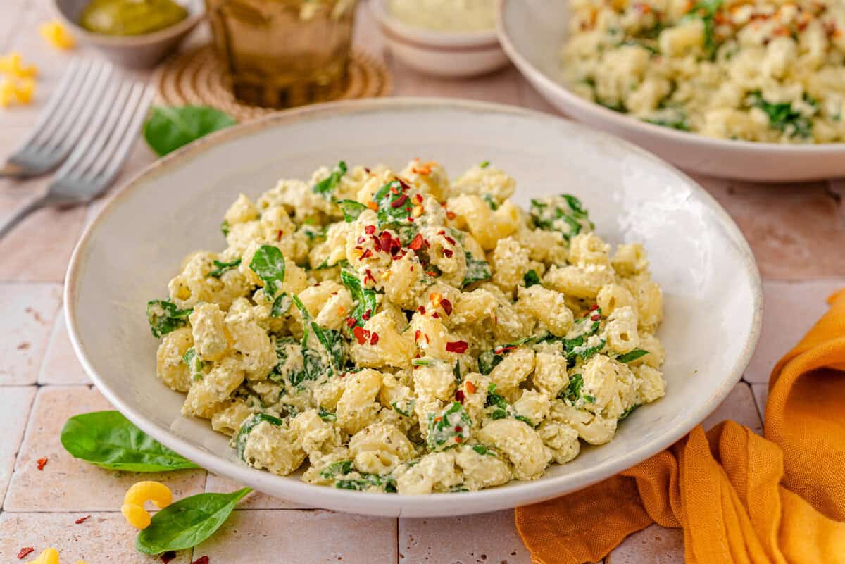 this shows me garnishing and serving the pasta.