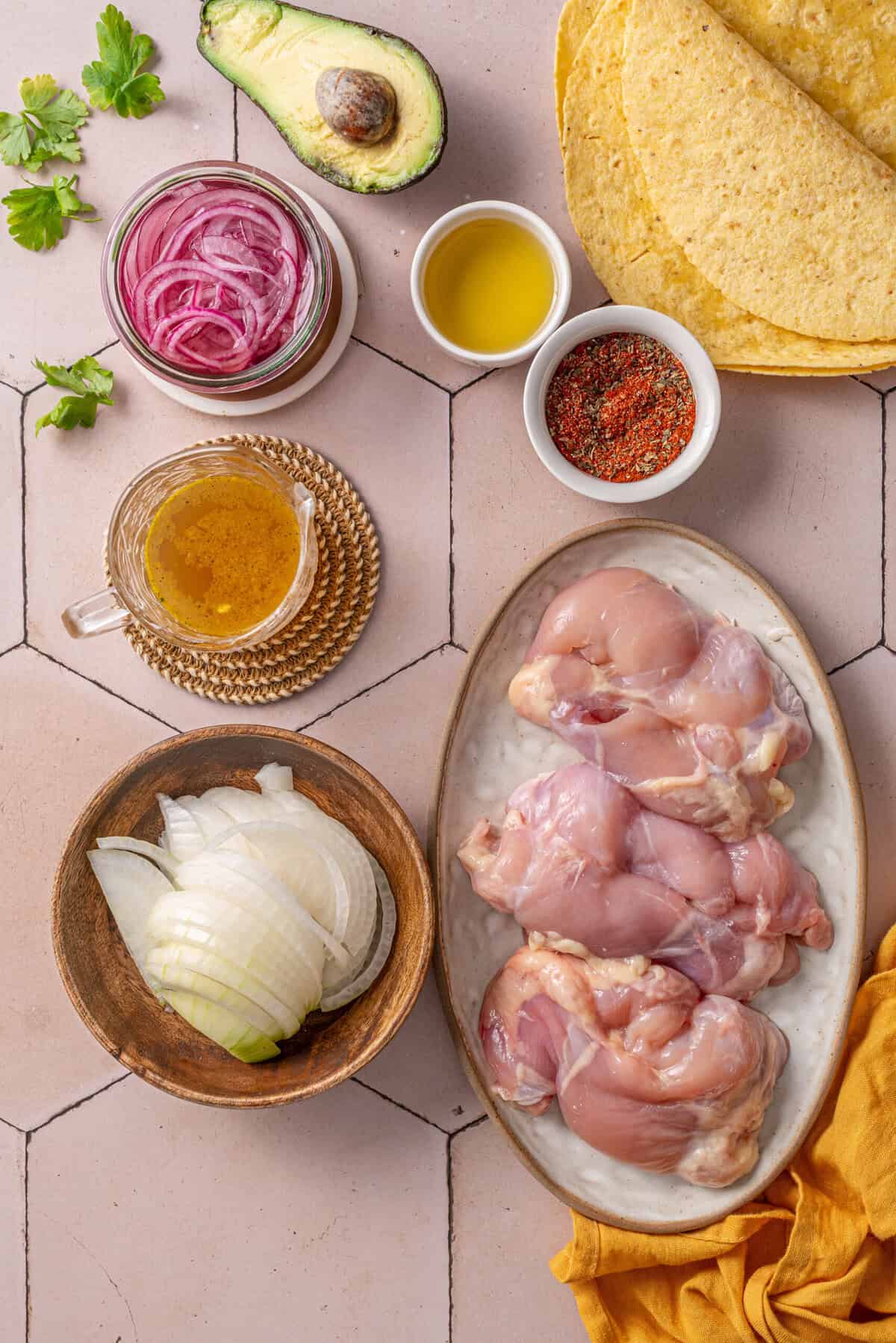Overhead shot of all ingredients needed for chicken tinga tacos.