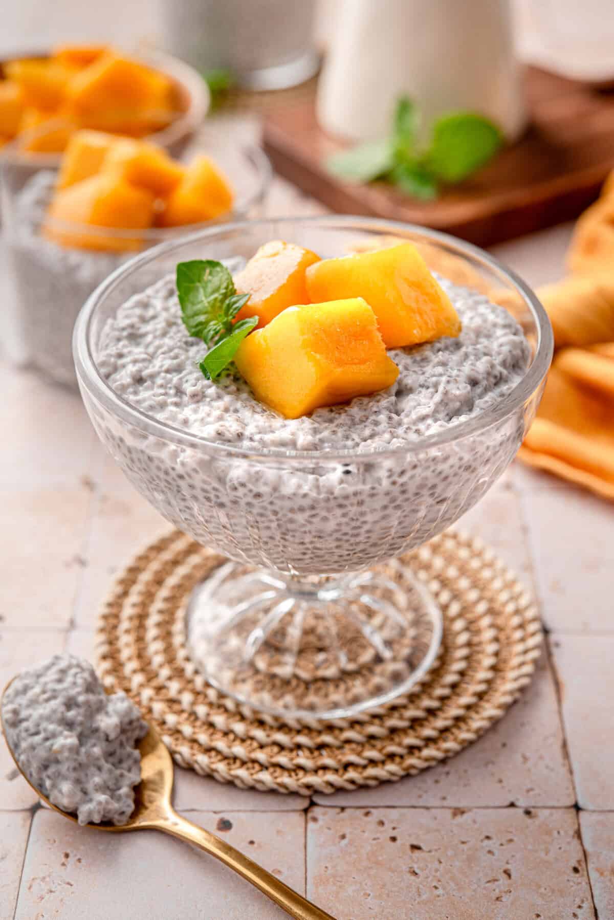 Close up side shot of my creamy coconut chia pudding topped with mango served.