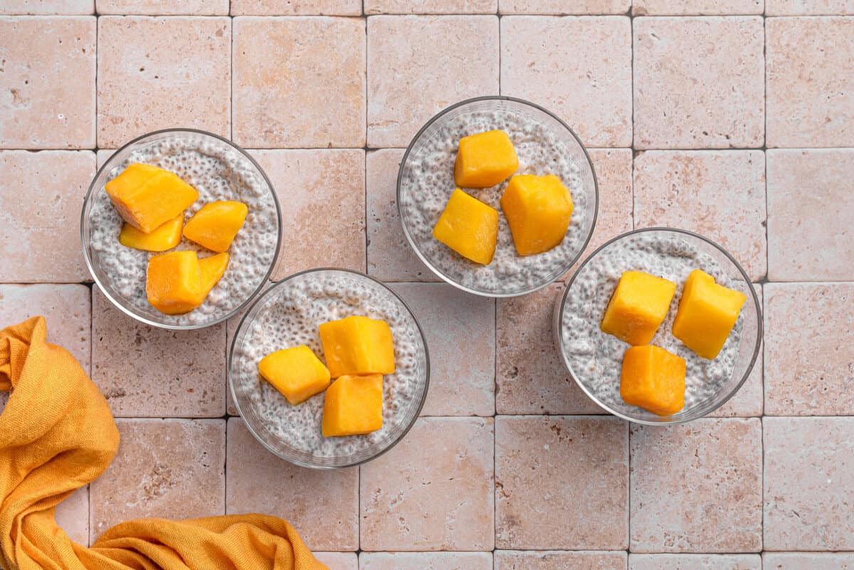 Overhead shot of chia pudding served topped with mango.