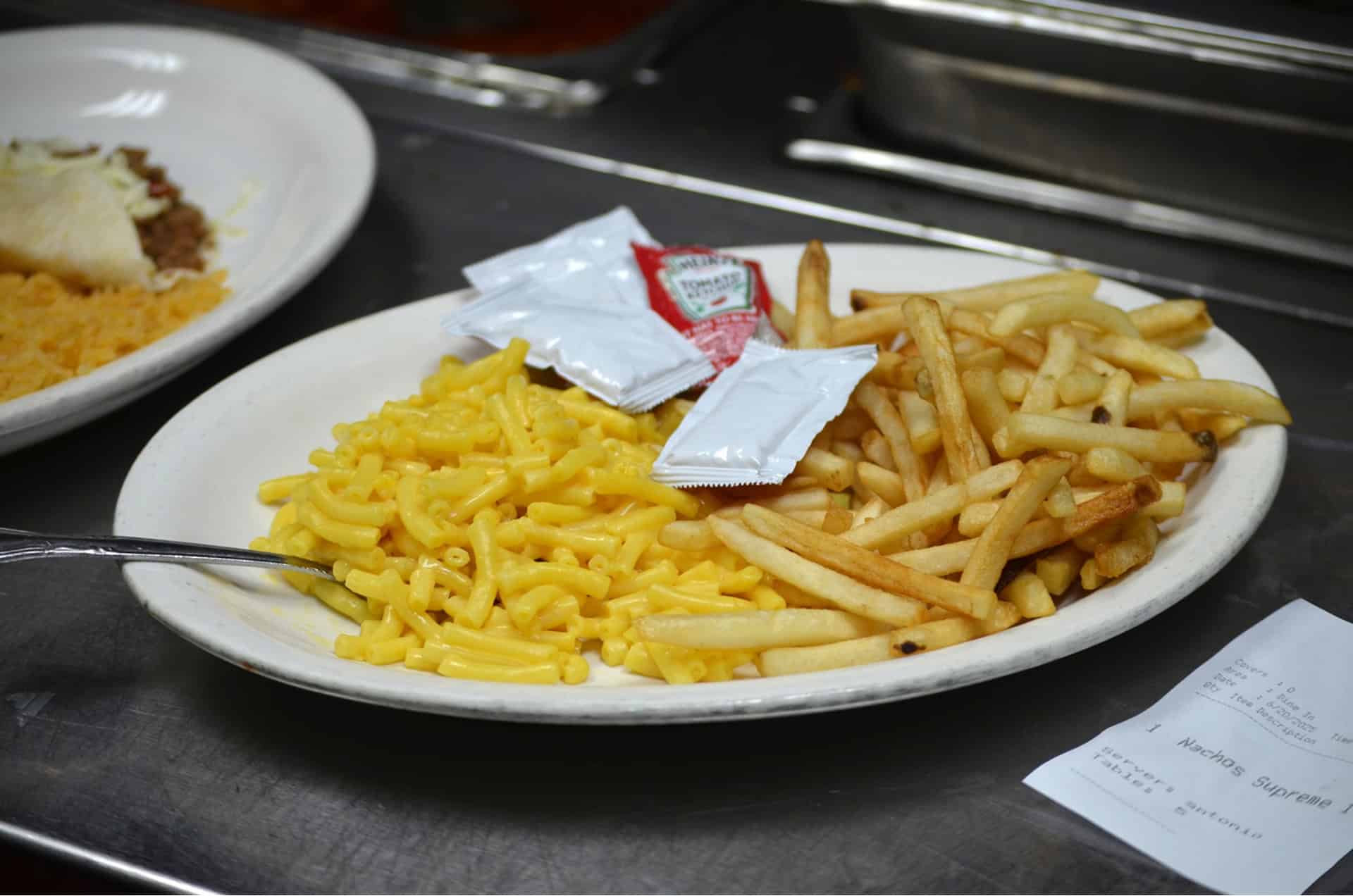 Kids meal with macaroni and cheese, French fries, and a small drink.