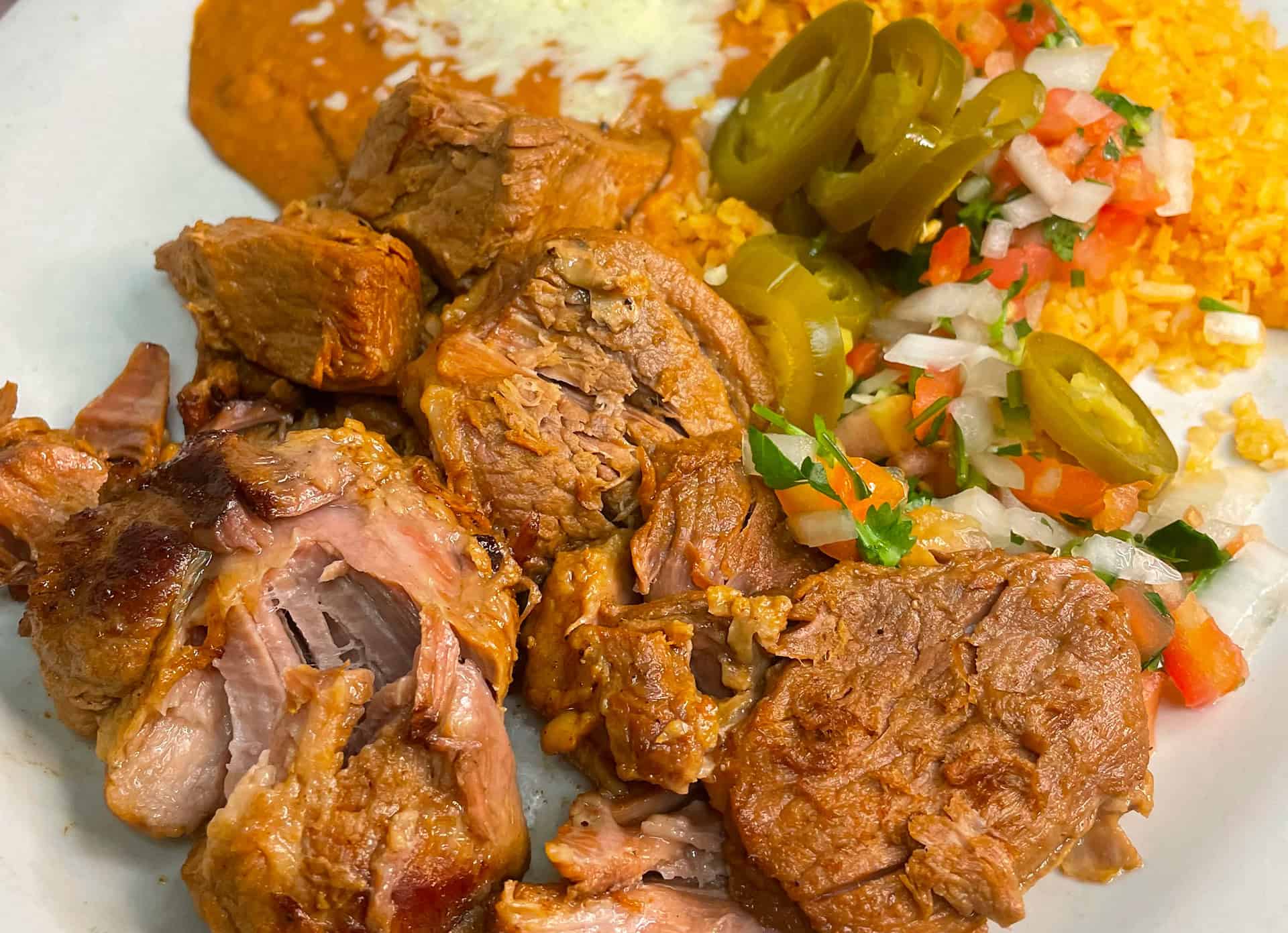 Delicious Mexican dishes with flavorful meats and fresh ingredients.