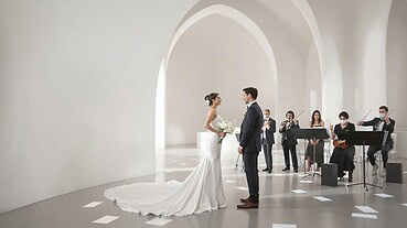 Elegant wedding ceremony with bride and groom exchanging vows in a minimalist, white architectural s.