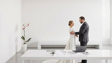 Bride and groom exchanging vows in a modern, minimalist wedding setting.