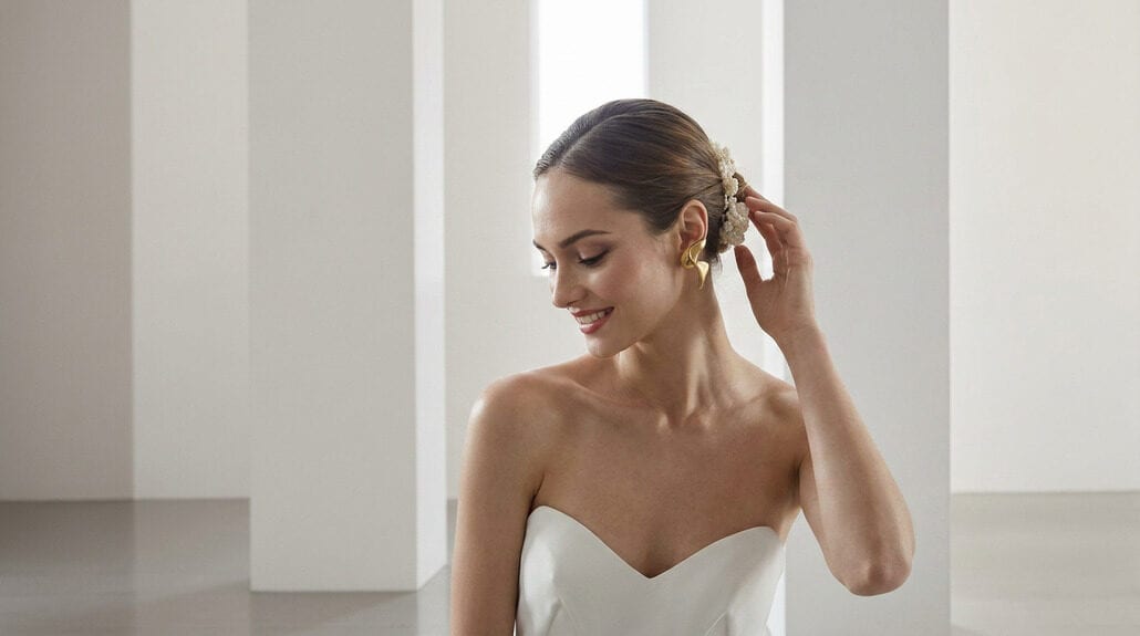 Bridal portrait featuring a bride with elegant makeup and hairstyle in a modern, minimalist setting.