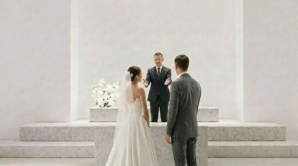 Bride and groom taking wedding vows in a modern, minimalist venue.