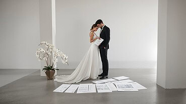 Bride and groom exchanging vows in a modern, minimalist wedding setting.