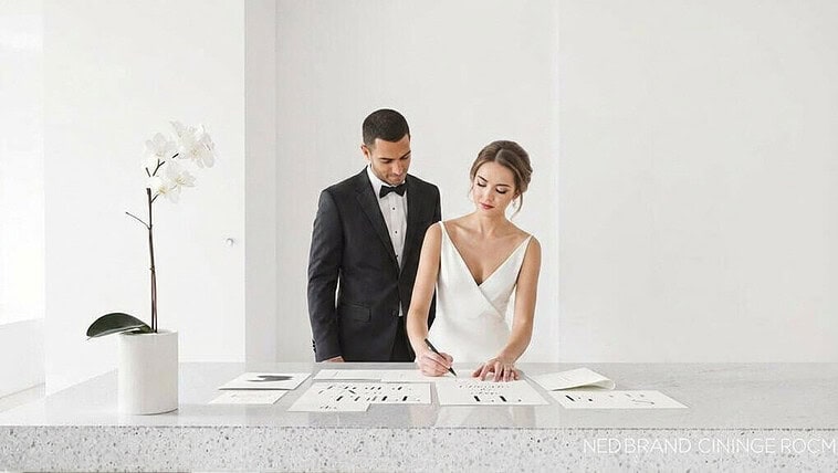 Wedding planning session with bride and groom reviewing designs and ideas.