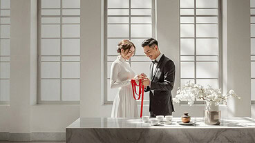 Bride and groom exchanging vows in a bright, modern wedding venue.