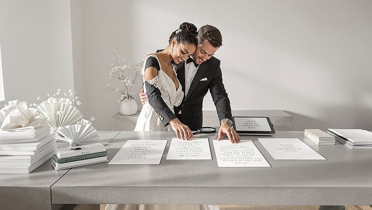 Elegant wedding couple signing marriage documents at a modern venue.