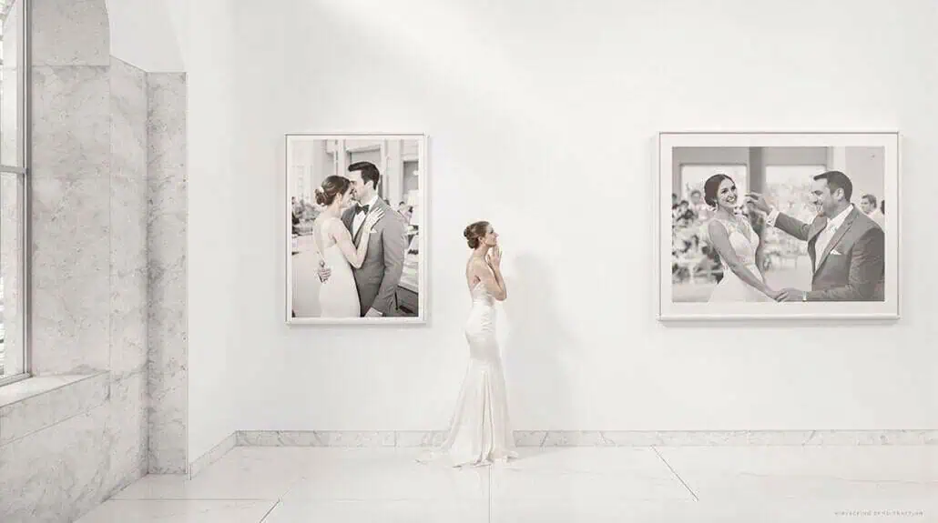 Bride and groom dancing in art gallery with black and white photos.