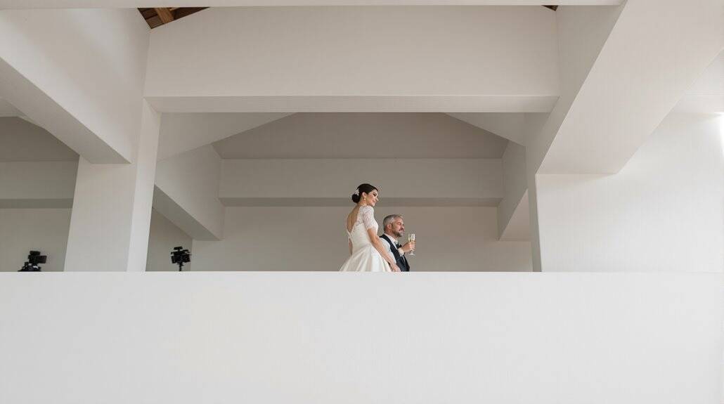Bride and groom standing on balcony during wedding celebration.