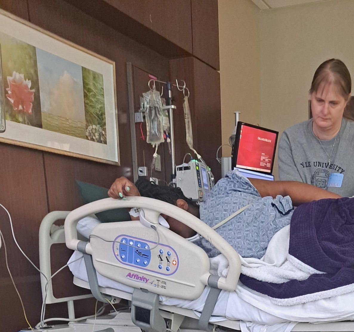 Rachel the birth doula helps a client get comfortable in bed, avoiding an episiotomy during a VBAC birth