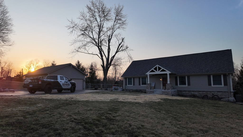 Newly installed roofing and siding on a charming home during sunset, showcasing quality and durability for real estate quality roofing and siding installation.